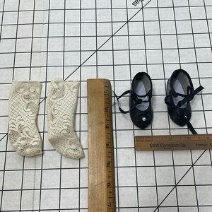 Pair of black doll shoes w/pearl& floral motif, pair of lace stockings